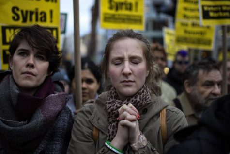 A protester reacts during a rally against the U.S. missile strikes in Syria, Friday, April 7, 2017, in New York. Hundreds of demonstrators took to New York City streets chanting