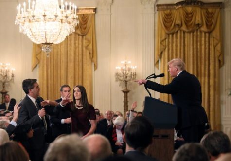 A White House staff member reaches for the microphone held by CNN's Jim Acosta as he questions U.S. President Donald Trump during a news conference following Tuesday's midterm U.S. congressional elections at the White House in Washington, U.S., November 7, 2018. REUTERS/Jonathan Ernst TPX IMAGES OF THE DAY