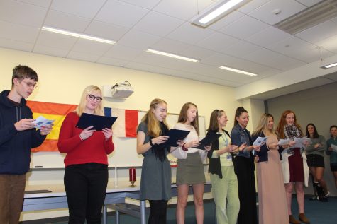 Inducting students to the French and Spanish Honor Societies