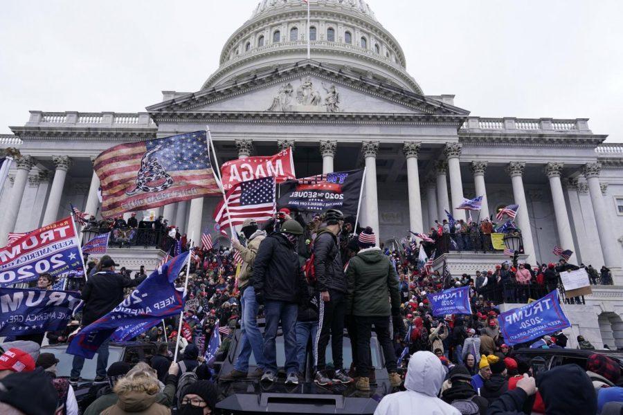 Trump Supporters climb and gather on the Capitol building
Image via Los Angeles Times