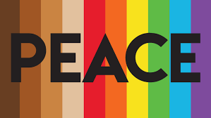 A rainbow peace flag that has 4 skin tones on the left side with bold black text in the middle