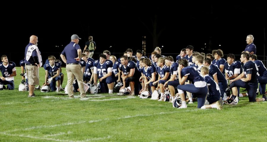 Coaches speak to players after the game