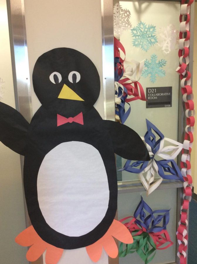 A decorated door with a penguin and snowflakes