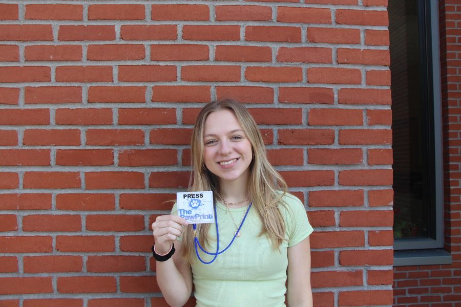 student holding pass