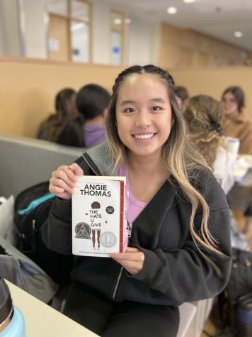 Sophomore Katie Nguyen holds The Hate U Give