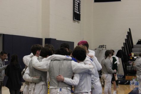 fencers huddle before a match
