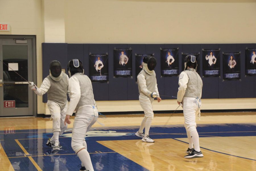 The mens foil squad warms up