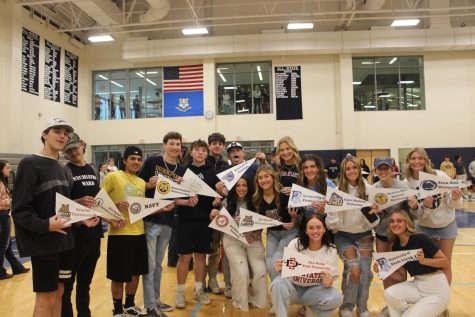 A group of seniors pose with their pennants