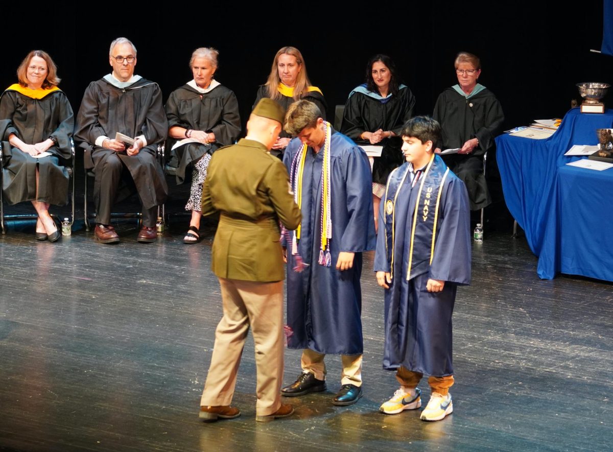 Robby Estabrook and Oscar Serrano receiving military recognition 