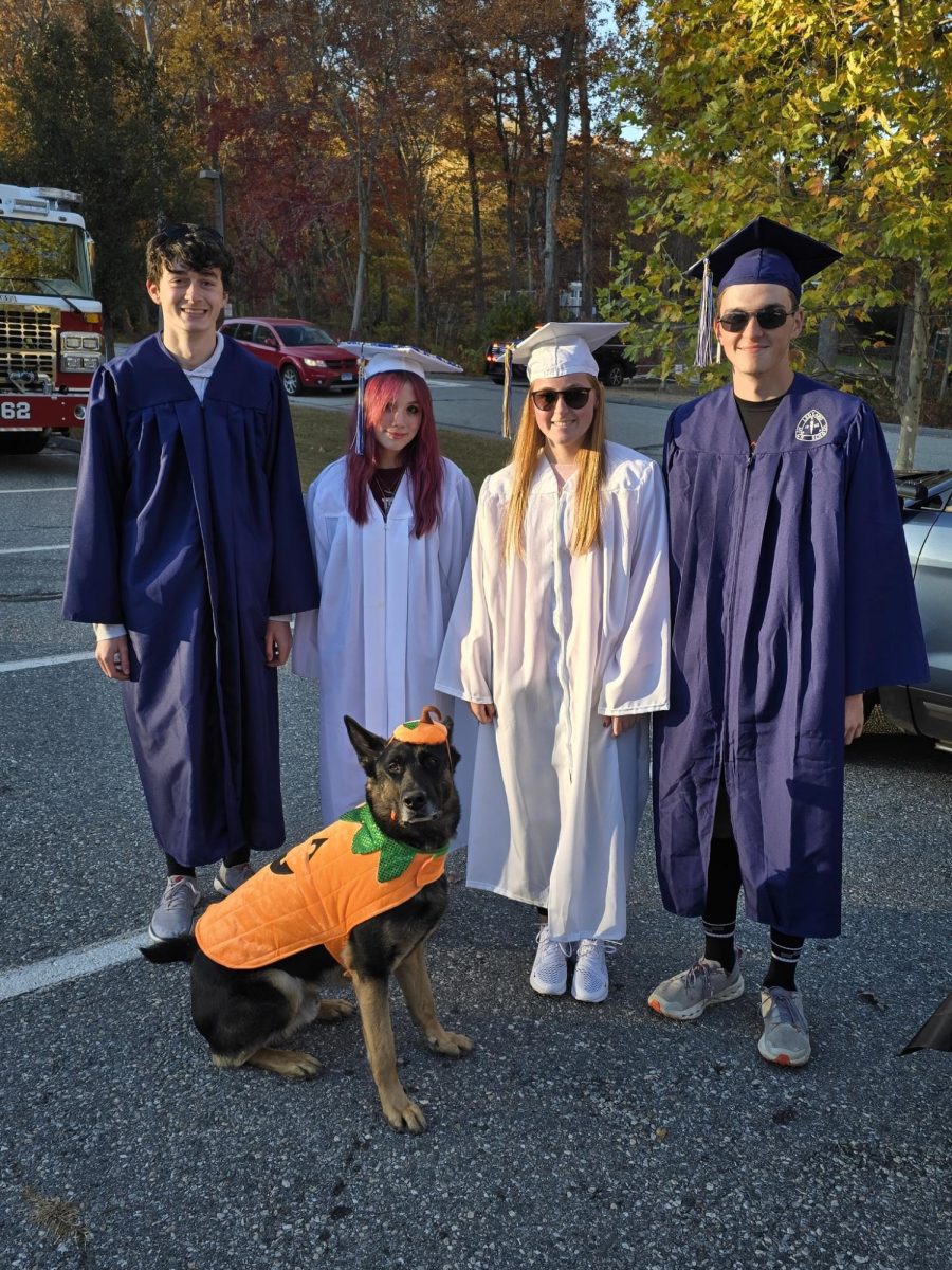 Jagger posing next to his peers in his pumpkin costume.