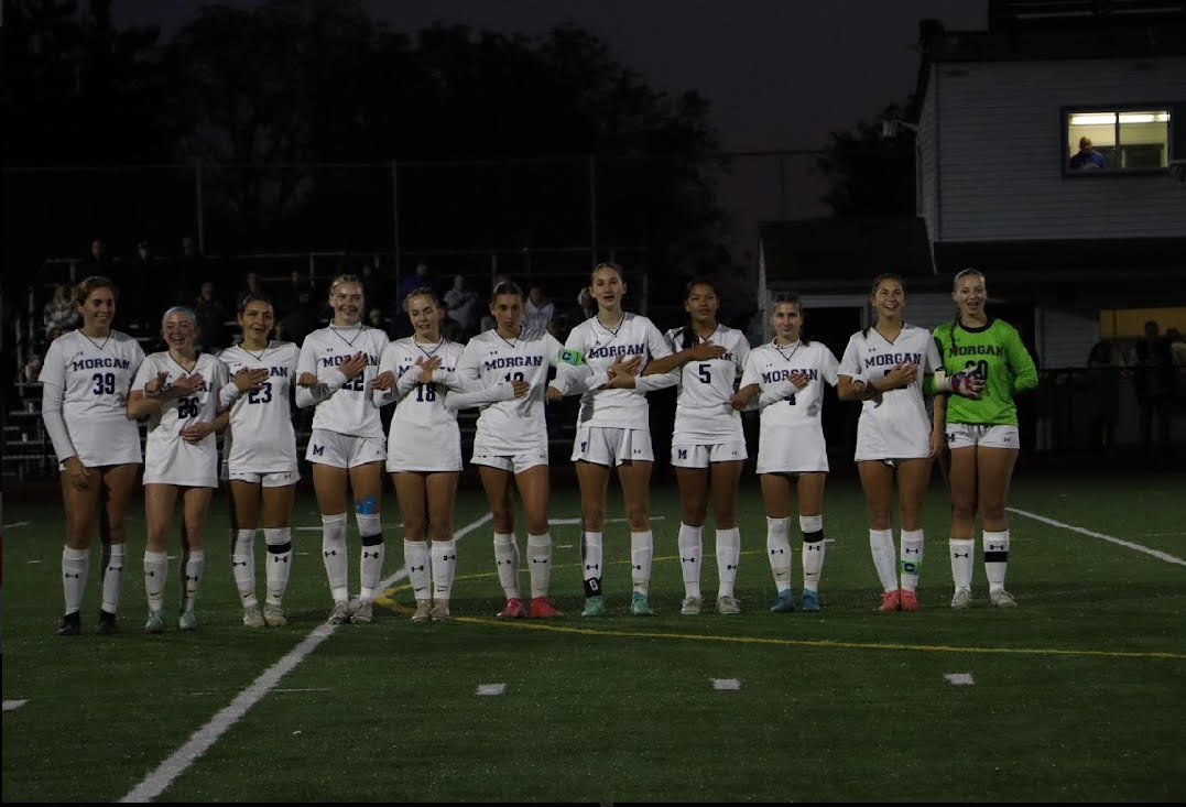 Morgan Girls soccer standing for national anthem