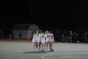 Morgan girls soccer team before game in huddle 