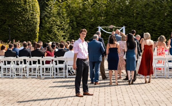 Alex DiStefano with a camera in hand at a wedding shoot.
