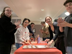 A group of Clinton GO attendees learning to cook.