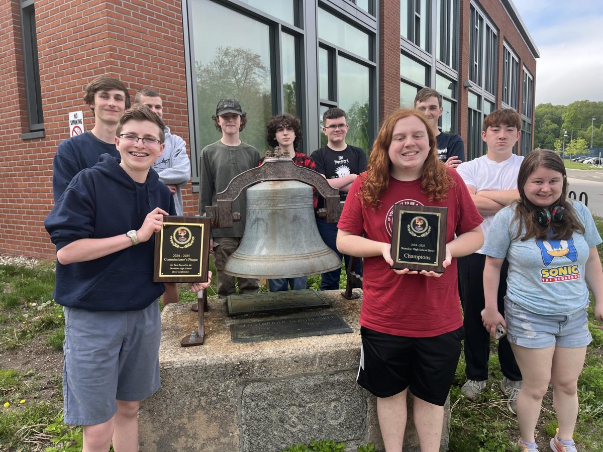 The Trivia Bowl Team standing in front of the bell outside of the Morgan School.