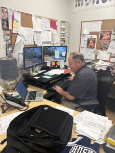 Mr. Cosgriff typing on his computer 