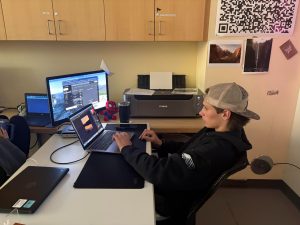 Student AJ Brown using his personal computer to do work