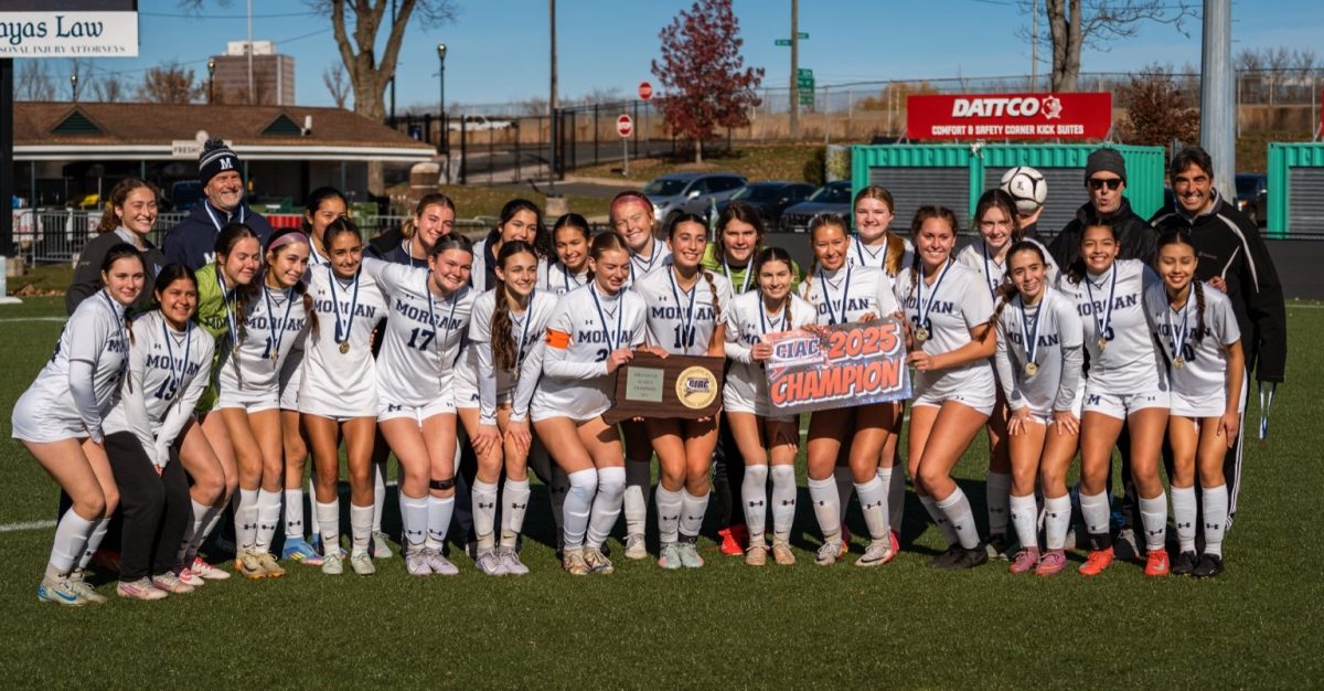 Morgan girls soccer team posing with their hardware
