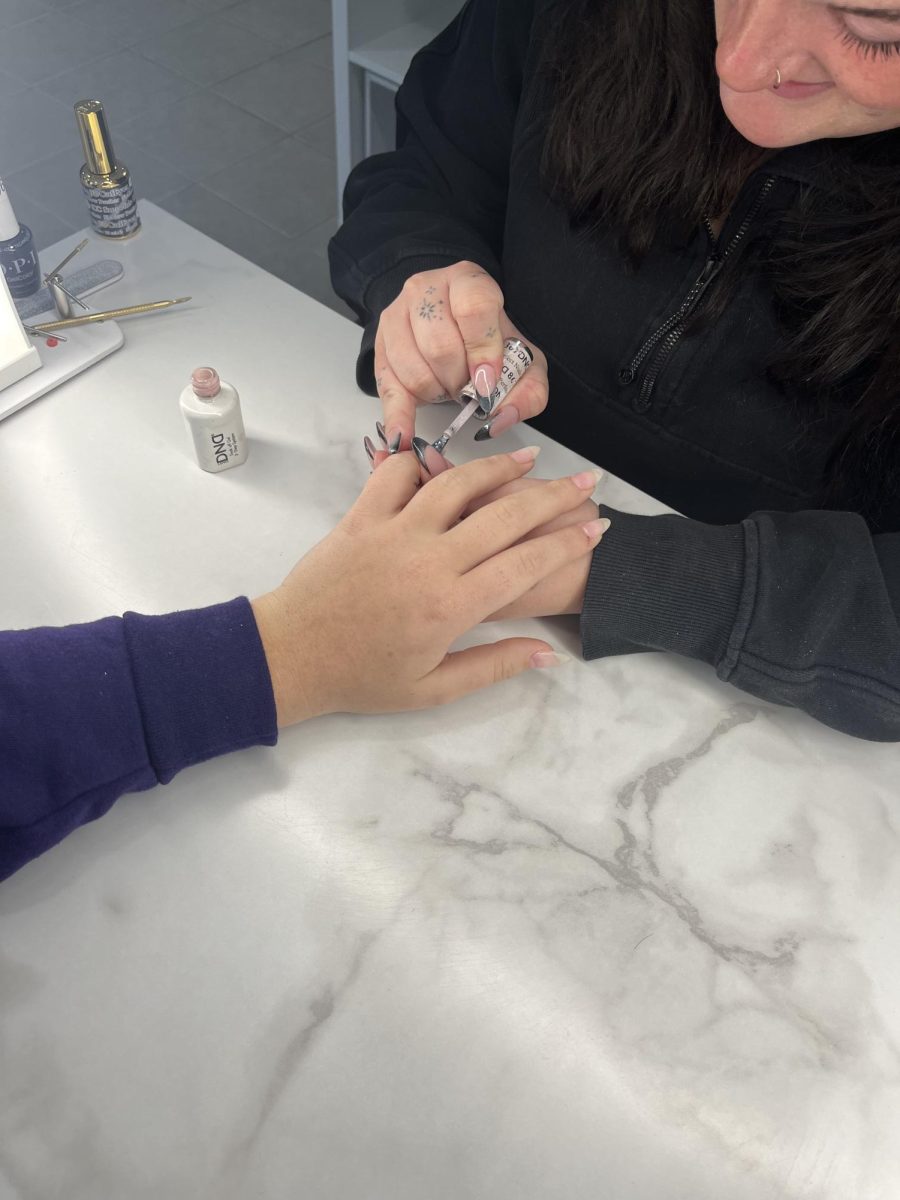 Lily Tanner doing a clients nails