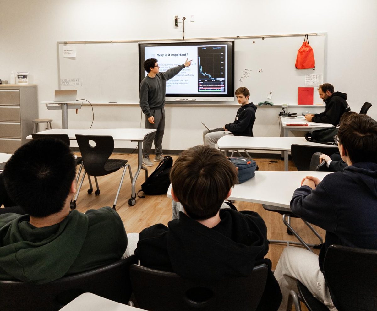 Jones and Winnicki teach club members the basics of finance