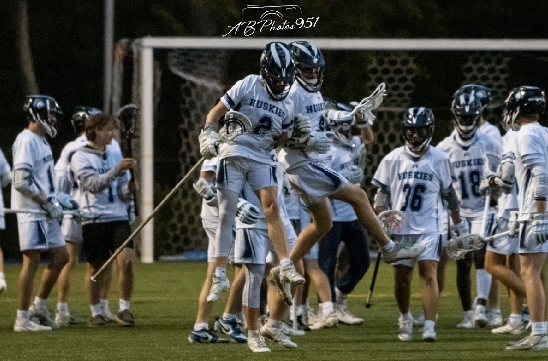 The Boys Lacrosse team celebrating together after a great win.