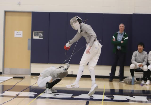 Morrissey jumps to attack his opponent, who crouches down in attempt to counter-attack.