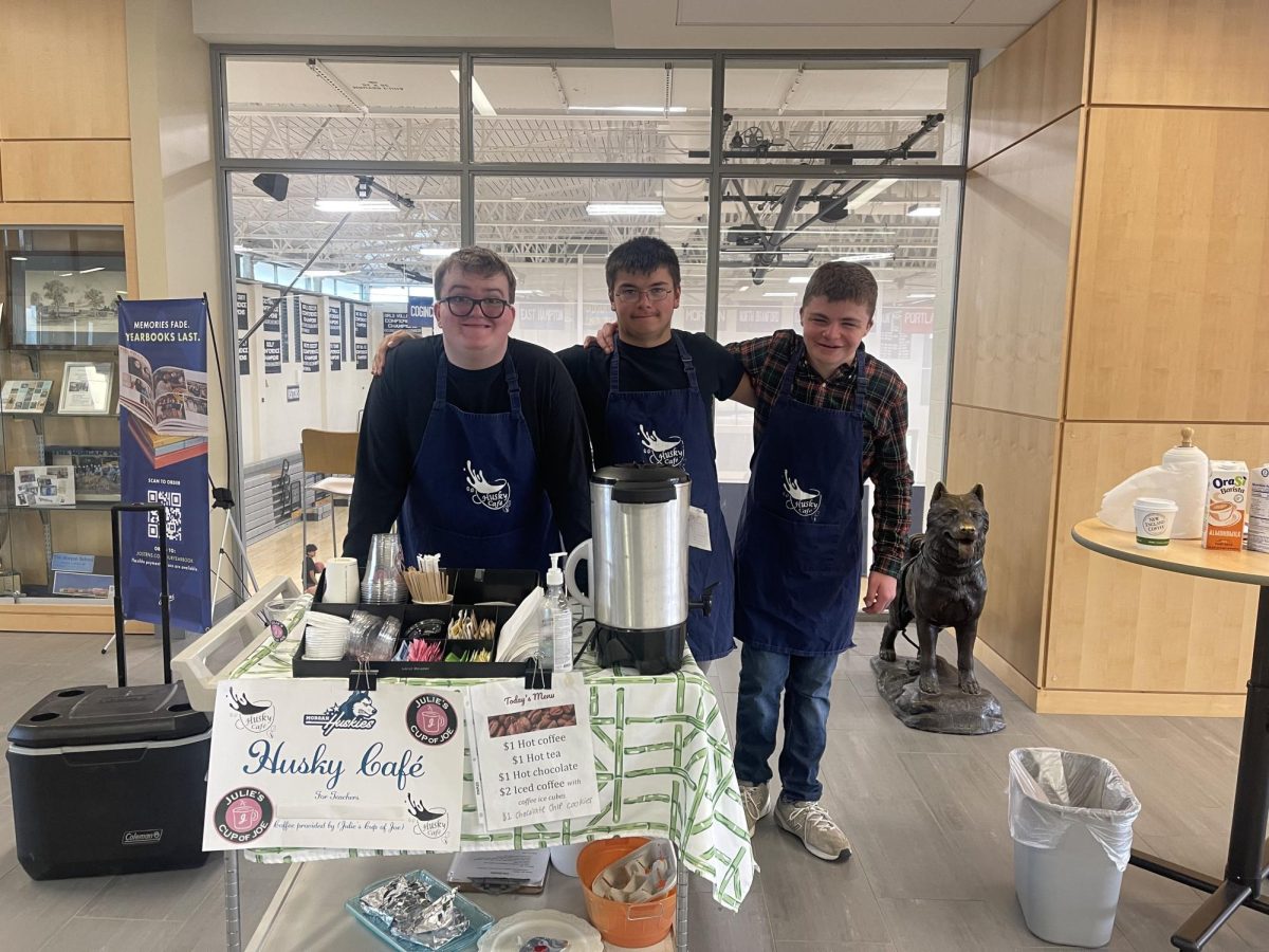Morgan's intensive learning program students standing behind the Coffee Cart.