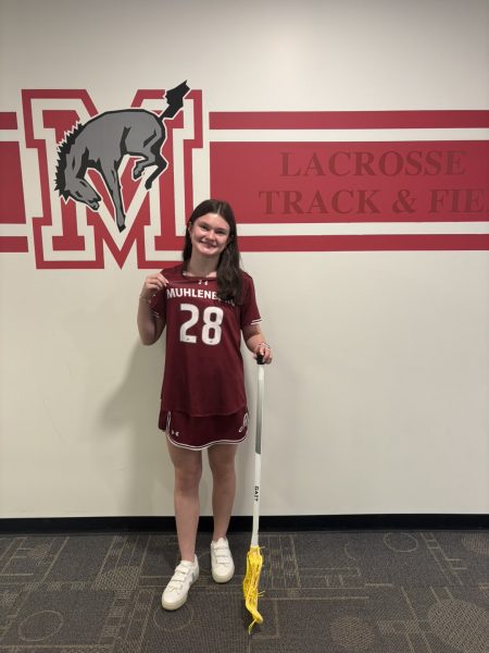 Emma Holecz on her officical visit trying on a Muhlenberg uniform