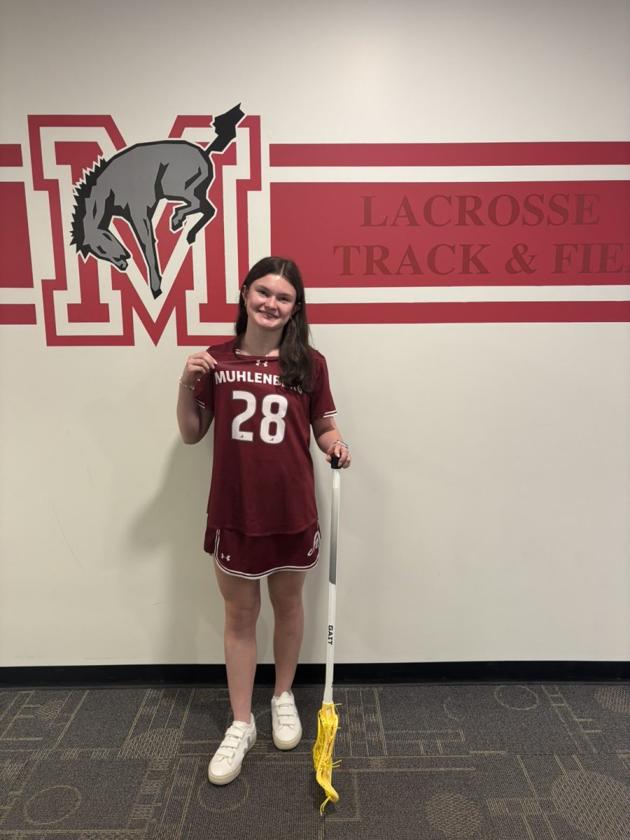 Emma Holecz on her officical visit trying on a Muhlenberg uniform