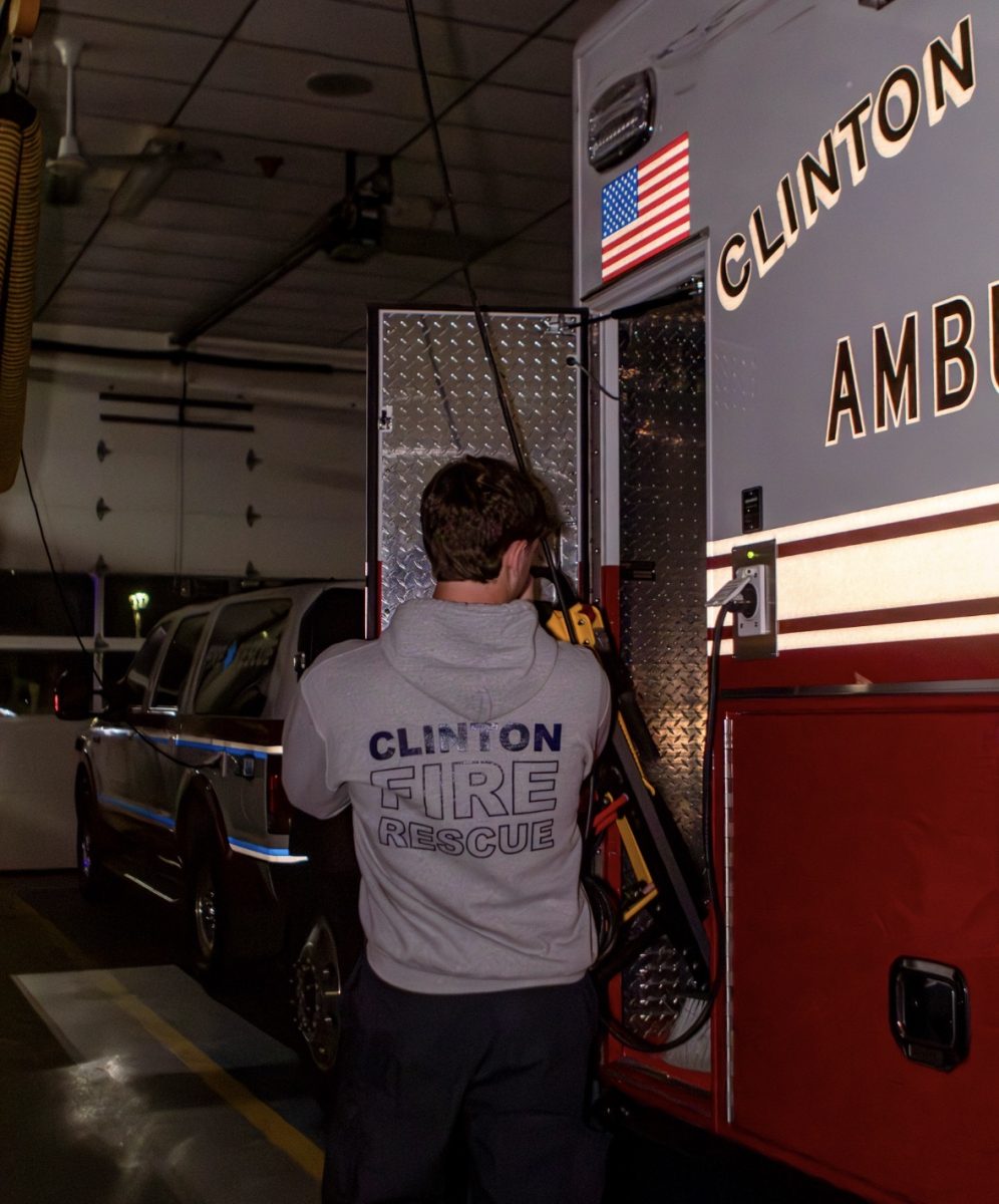 Nathan Levy putting the stair chair back in the ambulance after a call