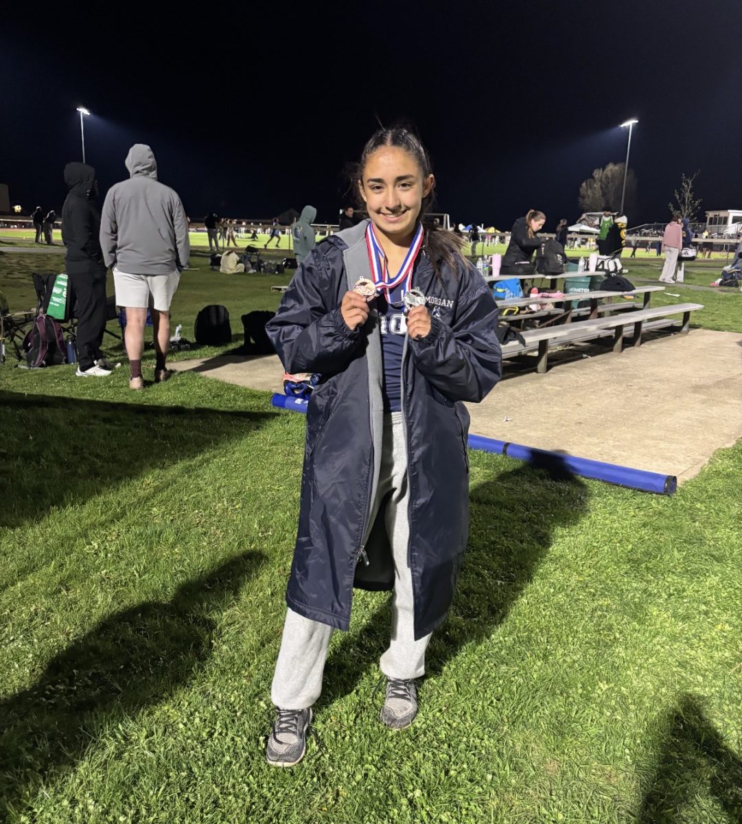 Massey holding her two medals after her meet at Ellington