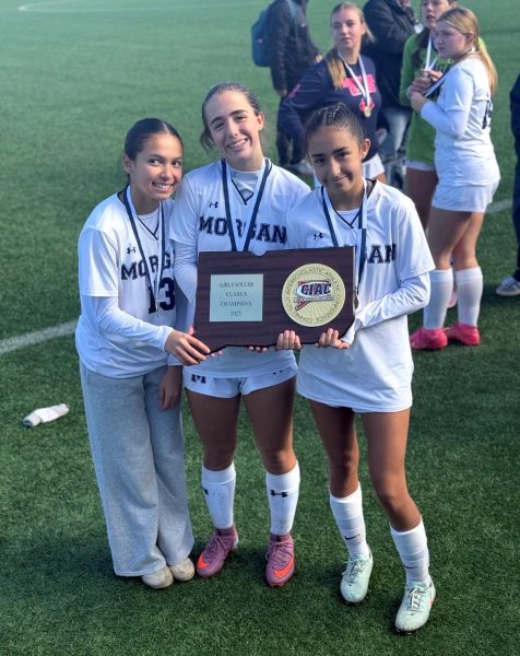 Photo of Addy Massey, Colbie LeClaire, and Katelyn Ramirez holding the  State Title plaque.